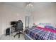 Bedroom featuring a black gaming chair and desk alongside a bed with a plaid comforter at 2563 Millbrook Dr, Haw River, NC 27258