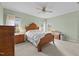 Comfortable bedroom with soft carpet, a ceiling fan, and a large wooden bed frame at 2563 Millbrook Dr, Haw River, NC 27258