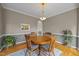 Elegant dining room with hardwood floors, a round table with chairs, and a view into another room at 2563 Millbrook Dr, Haw River, NC 27258