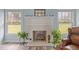 Close up of a fireplace mantle with an array of decor and natural light at 2563 Millbrook Dr, Haw River, NC 27258