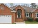 Close up of the front brick entrance with an arched doorway at 2563 Millbrook Dr, Haw River, NC 27258