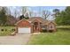 Lovely brick home with an attached garage and lush lawn at 2563 Millbrook Dr, Haw River, NC 27258