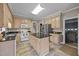 Bright kitchen boasting an island, wooden cabinetry, and modern appliances at 2563 Millbrook Dr, Haw River, NC 27258
