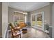 Bright living room with hardwood floors, natural light, rocking chair, and backyard access at 2563 Millbrook Dr, Haw River, NC 27258