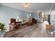 Spacious living room with wood floors, light blue walls, and multiple seating areas at 2563 Millbrook Dr, Haw River, NC 27258