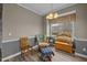 Inviting living room featuring natural light, hardwood floors, wooden chairs, and a decorative bench at 2563 Millbrook Dr, Haw River, NC 27258