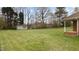 A well-manicured lawn with a shed, offering serene outdoor living and storage solutions at 2563 Millbrook Dr, Haw River, NC 27258