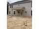 Exterior back view of the home under construction with a patio and siding at 268 Dove Rd, Cameron, NC 28326