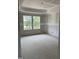 Bedroom under construction featuring a tray ceiling and two windows overlooking trees at 268 Dove Rd, Cameron, NC 28326