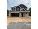 Two story home with large garage and craftsman design details under construction with dirt front yard at 268 Dove Rd, Cameron, NC 28326