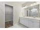 Bathroom with double sink vanity, tile flooring, and walk-in closet at 280 Providence Creek Dr, Fuquay Varina, NC 27526