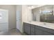 Bathroom featuring double sink vanity, large mirror, tile floor and tiled shower at 280 Providence Creek Dr, Fuquay Varina, NC 27526