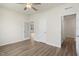 Bright bedroom with hardwood floors, a ceiling fan, and glass panel doors at 280 Providence Creek Dr, Fuquay Varina, NC 27526