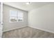 Bedroom with neutral carpeting, large window, and natural light at 280 Providence Creek Dr, Fuquay Varina, NC 27526