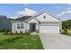 Charming single-story home with a well-manicured lawn and attached two-car garage at 280 Providence Creek Dr, Fuquay Varina, NC 27526