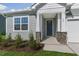 Close-up of the welcoming front porch featuring stone accents and a modern-style front door at 280 Providence Creek Dr, Fuquay Varina, NC 27526