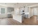 Well-lit kitchen with gray cabinets, a center island, granite countertops, and stainless steel appliances at 280 Providence Creek Dr, Fuquay Varina, NC 27526