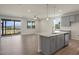 Modern kitchen with stainless steel appliances, an island with granite countertops, and an open view of the living area at 280 Providence Creek Dr, Fuquay Varina, NC 27526