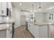 Stylish kitchen with white cabinetry, granite countertops, stainless appliances, and an open layout for entertaining at 280 Providence Creek Dr, Fuquay Varina, NC 27526