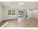 Spacious living room with hardwood floors and natural light, with access to outdoor patio at 280 Providence Creek Dr, Fuquay Varina, NC 27526