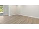 Bright living room with hardwood floors and access to outdoor patio at 280 Providence Creek Dr, Fuquay Varina, NC 27526