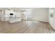 Open concept living room and kitchen with breakfast bar, recessed lights, and wood floors at 280 Providence Creek Dr, Fuquay Varina, NC 27526
