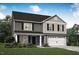 Charming two-story home featuring a gray exterior, black shutters, and a two-car garage at 290 Shiloh Way, Mebane, NC 27302