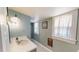 Charming bathroom featuring a white sink, patterned tile floor, and a wall sconce at 308 College St, Oxford, NC 27565