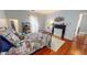 Cozy bedroom featuring a metal frame bed, neutral walls, and hardwood floors at 308 College St, Oxford, NC 27565