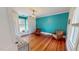 Bedroom with hardwood floors, light turquoise colored walls and two comfy chairs at 308 College St, Oxford, NC 27565