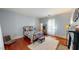 Comfortable bedroom with hardwood floors, a metal frame bed, and neutral walls at 308 College St, Oxford, NC 27565