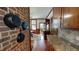 Elegant dining area with exposed brick wall, wood floors, and custom wood cabinetry at 308 College St, Oxford, NC 27565
