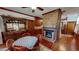 Cozy dining room with brick fireplace, wood floors, and antique hutch at 308 College St, Oxford, NC 27565