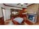 Cozy dining room with a fireplace, wood floors, and a vintage china cabinet at 308 College St, Oxford, NC 27565