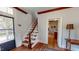 Charming entryway with stairs and exposed brick view, featuring hardwood floors and natural light at 308 College St, Oxford, NC 27565