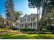 Beautiful two-story yellow home with wrap-around porch and landscaped lawn at 308 College St, Oxford, NC 27565