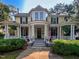 Stunning two-story yellow home with wrap-around porch, stately columns, and manicured front yard at 308 College St, Oxford, NC 27565