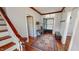 Spacious foyer with hardwood floors, an area rug, a dark-stained door and wooden trim at 308 College St, Oxford, NC 27565