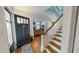 Grand foyer with staircase, wooden floors, and a glimpse of the living room at 308 College St, Oxford, NC 27565