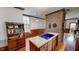 Well-lit kitchen featuring wood floors, exposed brick accents, and white countertops at 308 College St, Oxford, NC 27565