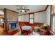 Relaxing living room with brick fireplace, sofa, and natural light from the window at 308 College St, Oxford, NC 27565