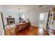 Comfortable living room featuring a fireplace, plaid sofa, and hardwood floors at 308 College St, Oxford, NC 27565