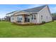 Backyard featuring a covered patio, well-maintained lawn, and fresh landscaping at 312 Providence Creek Dr, Fuquay Varina, NC 27526