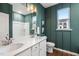 Elegant bathroom featuring double vanity, bright lighting, and a shower, designed for relaxation at 312 Providence Creek Dr, Fuquay Varina, NC 27526