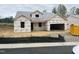 Unfinished home exterior shows construction with wrapped walls and framed windows, ready for customization at 312 Providence Creek Dr, Fuquay Varina, NC 27526