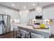 Bright kitchen with a large island, pendant lighting, and stainless steel appliances at 312 Providence Creek Dr, Fuquay Varina, NC 27526