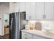 Well-lit kitchen with stainless steel refrigerator and white subway tile backsplash at 312 Providence Creek Dr, Fuquay Varina, NC 27526