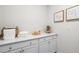 Bright laundry room with ample storage, a folding area, and stylish decor for added convenience at 312 Providence Creek Dr, Fuquay Varina, NC 27526
