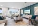 Bright living room featuring stylish decor, comfortable seating, and a large window with neighborhood views at 312 Providence Creek Dr, Fuquay Varina, NC 27526