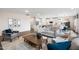 Open-concept living space with a view of the modern kitchen, dining area, and comfortable seating at 312 Providence Creek Dr, Fuquay Varina, NC 27526